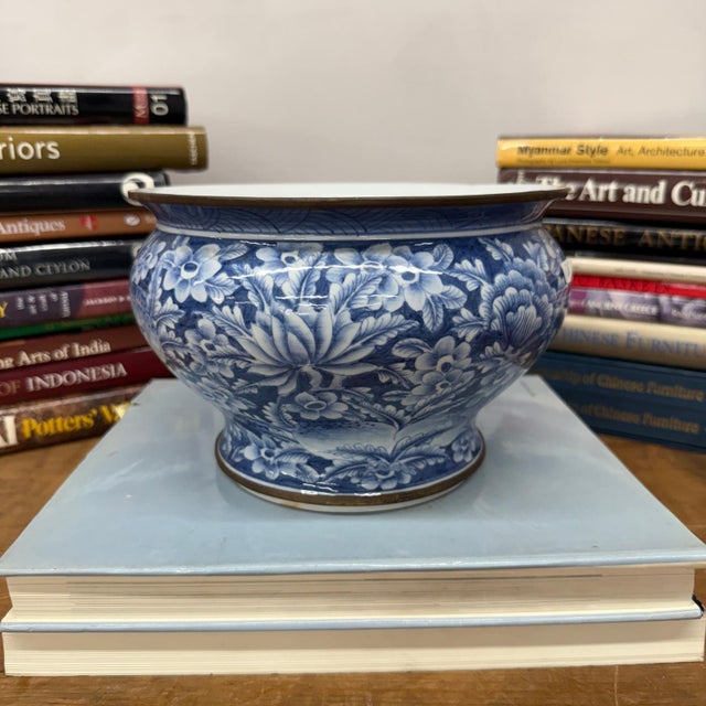 "About This Piece About This Piece Softly luminous under any light, this blue-and-white porcelain jardinière captures...