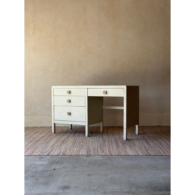 This desk brings clean, architectural lines to industrial design — a streamlined metal case finished in warm ivory, with...