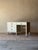 This desk brings clean, architectural lines to industrial design — a streamlined metal case finished in warm ivory, with...