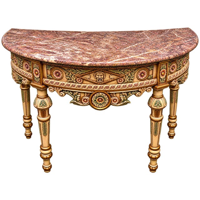 A beautifully ornate Italian Neoclassical-style demilune console table, featuring an exceptionally detailed hand-carved...