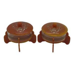 Early 20th Century Art Deco Cinnamon Brown Bakelite Round Footed Boudoir Lidded Powder Jars With Asian Grapevine Design - a Pair