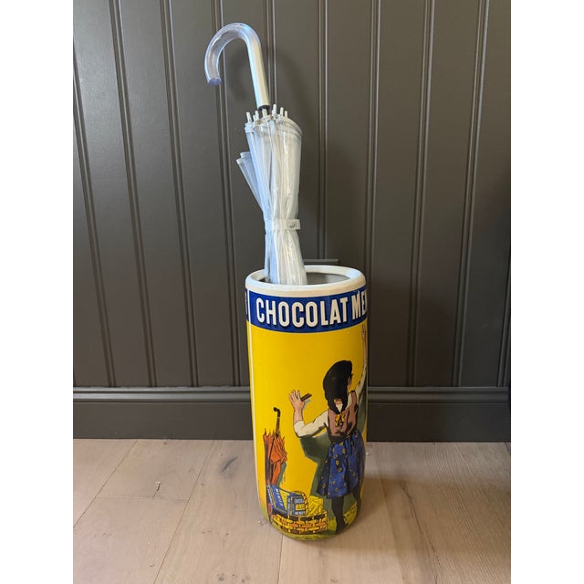 A charming vintage French advertising ceramic umbrella stand featuring the celebrated Chocolat Menier artwork created by...