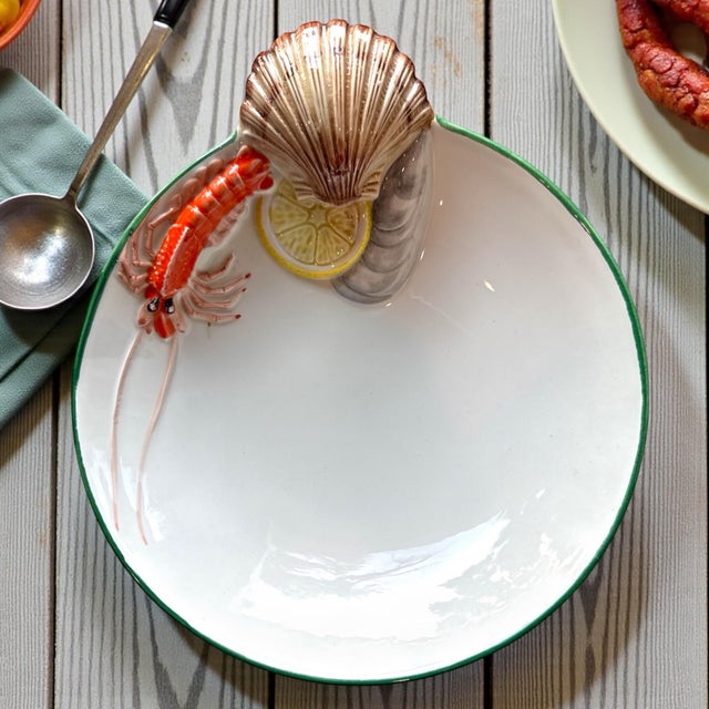 A beautifully sculptural Italian hand-made ceramic serving bowl, measuring approximately 8½ inches in diameter, featuring...