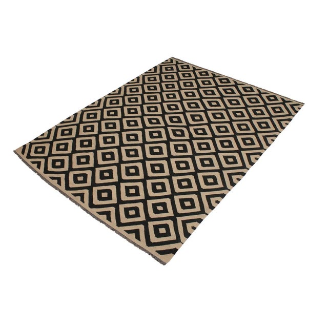 Add a touch of elegance to your home with this casual chic hand woven Tribal Kilim wool rug. Constructed on a loom by...