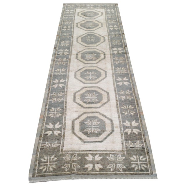 Hand-knotted with care using traditional rug making techniques, this wool rug blends timeless craftsmanship with a modern...