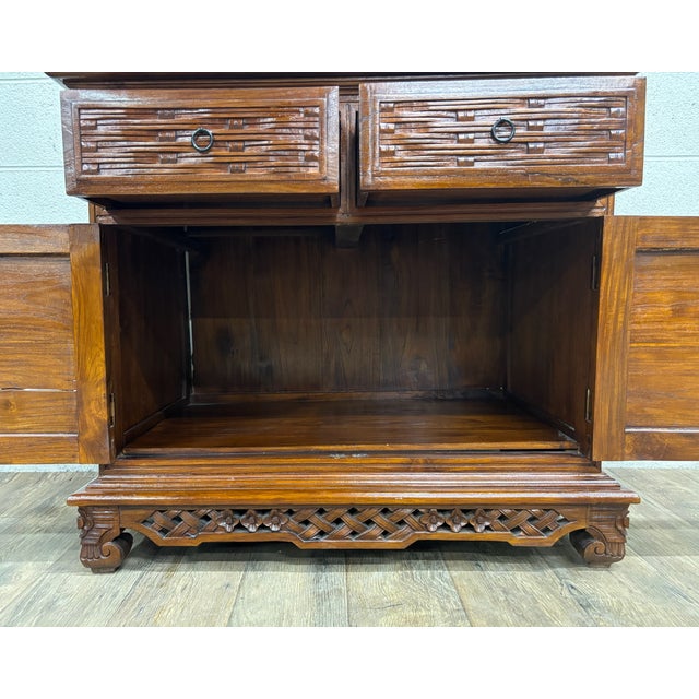 This is a gorgeous vintage, possibly antique, Indonesian storage cabinet believed to be Elm in a stunning Asian style....