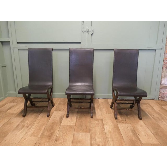 A Set of 3 Mid Century Leather and Oak Fireside Sling Chairs by Pierre Lottier A Classic By Pierre Lottier the Chairs are...