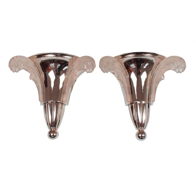Art Deco wall lamps by "Ezan". France, circa 1930. Nickel-plated brass. White ornamental glass shades in a feathery...