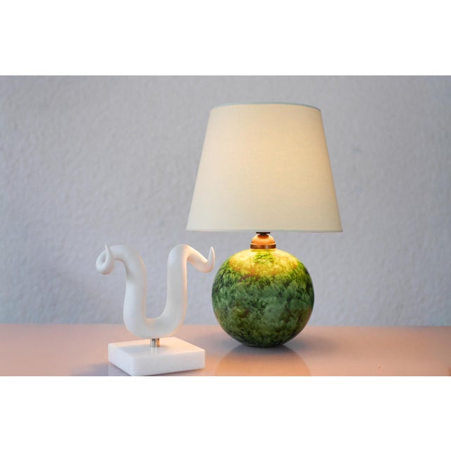 An extraordinary Art Deco table lamp from the 1930s, showcasing an exceptional glaze and a refined expression of Swedish...