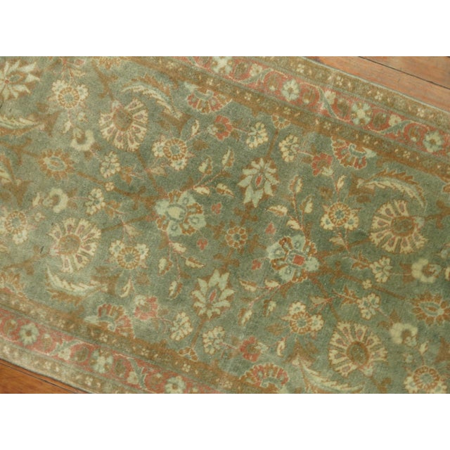 Decorative Persian antique Tabriz one-of-a-kind antique narrow runner from the 1940s in brown and green. Measures: 2'4” x...