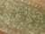 Decorative Persian antique Tabriz one-of-a-kind antique narrow runner from the 1940s in brown and green. Measures: 2'4” x...
