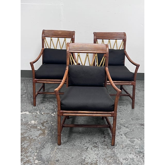 Design Plus Gallery presents a Set of Three McGuire Style Bamboo & Rattan Armchairs. Each chair has a bamboo and rattan...