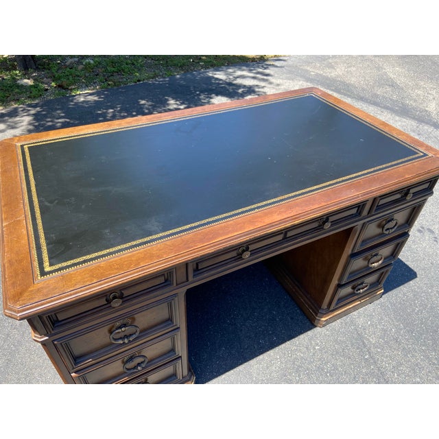 This Vintage Sligh Furniture Leather Top Executive Desk is a stunning piece from the 1960s, showcasing an antique brass...