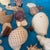 Noah’s Ark Coastal Centerpiece: Woven Boat Basket Overfilled With Sea Shells For Sale - Image 11 of 11