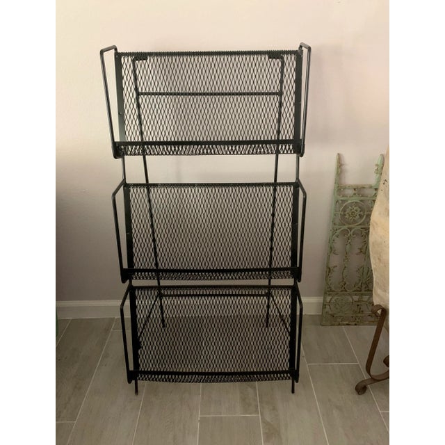 A great display item for your books, magazines or any media. Three iron and mesh shelves that can fold up flat for...