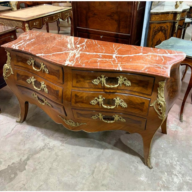Bring timeless European elegance to your interior with this grand French Louis XV-inspired commode, crafted with a...