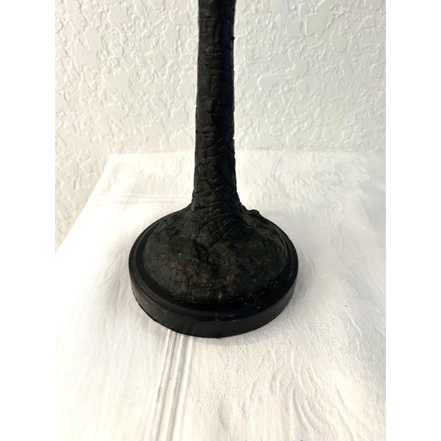 Vintage pair of iron taper candle holders in a figural palm tree design featuring a climbing and swinging monkey. Generous...