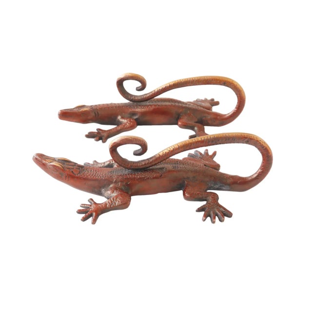 A pair of red brass lizard door handles or cabinet pulls with curled tails. Pressed with simple details to convey skin,...
