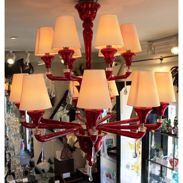 Stunning Red Chandelier by world renowned Barovier & Toso, Murano. This 15 Light fixture is a beautiful deep red color and...