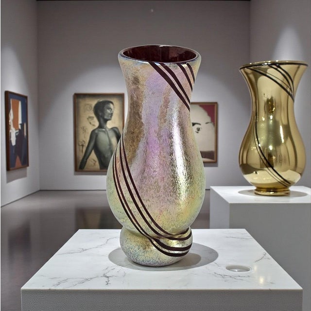 This studio art glass vase was created by American glass artist Minh Martin and dates to the early 2000s. The vessel is...