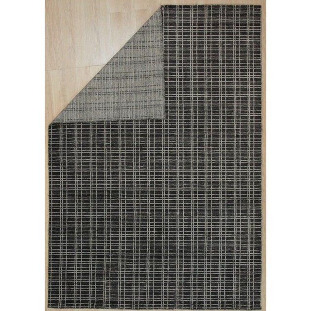 This hand knotted pile rug features a primary brown earth tone and is constructed from a blend of wool and viscose....