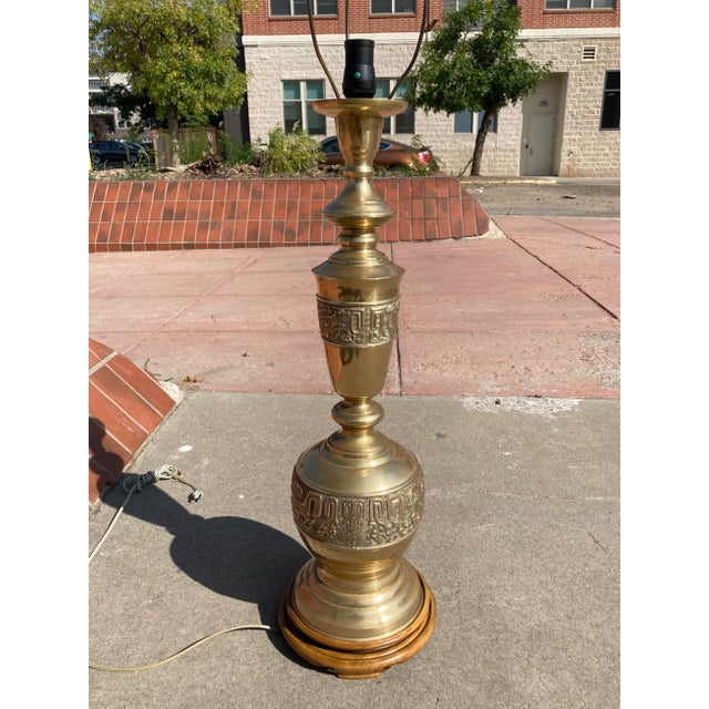 James Mont style tall brass and carved wood base table lamp manner of Marbro, manufactured in Japan, circa 1950s. Piece...