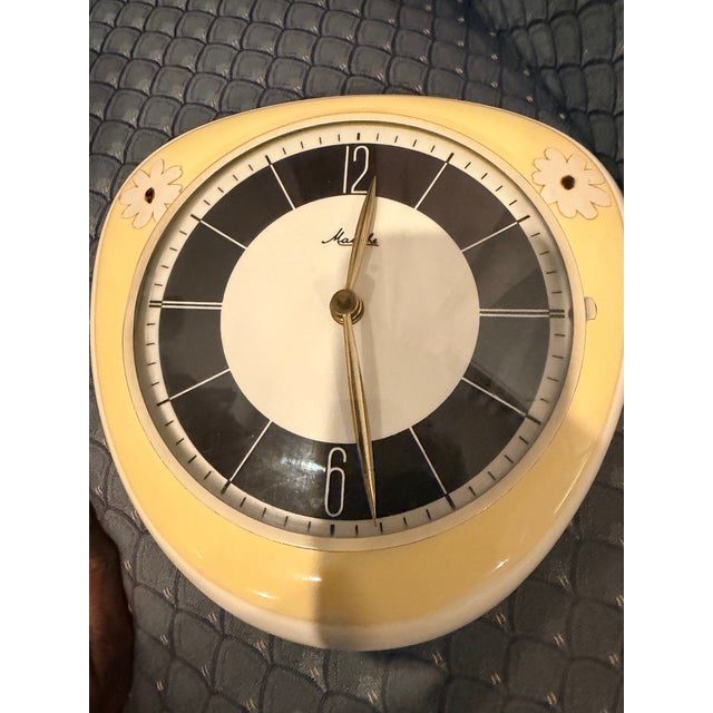 This charming Mauthe wall clock is a wonderful example of 1950s West German ceramic craftsmanship. The creamy pastel...