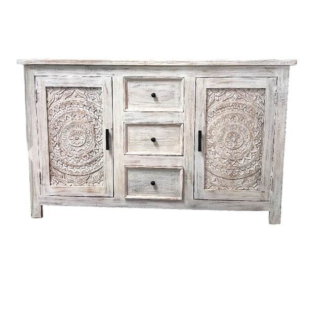 Whitewashed solid Mango wood cabinet with 2 laser cut doors and 3 drawers. Accented with black iron hardware. Plenty of...