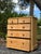 A beautiful antique English pine chest of drawers dating to the late 19th century, showcasing the warm honey-toned patina...