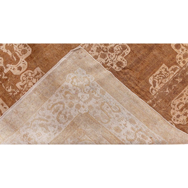 An early 20th century Indian Amritsar antique rug, the tan field with an unusual symmetrical design of strap work and...