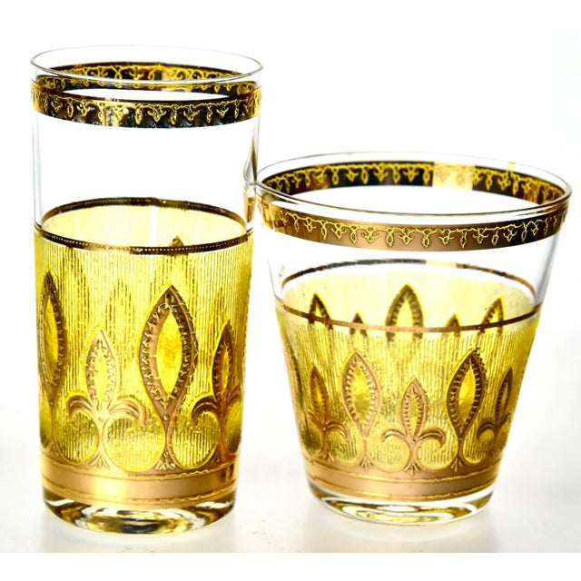 A spectacular 16 piece set of 22k gilt glasses, comprising of eight lowball glasses and eight highballs (Culver glasswares...