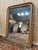 A Louis Philippe period mirror, entirely gilded with gold leaf, a remarkable testament to 19th-century craftsmanship. This...