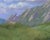 Flatirons by Kirsten Savage | Oil on panel Painting of rocky mountains under a blue sky For Sale - Image 4 of 5