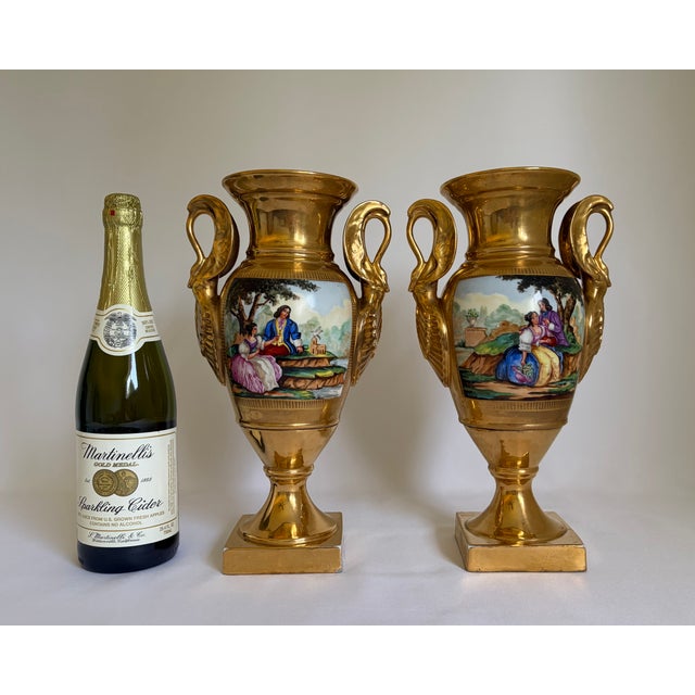 A striking matched pair of antique French Old Paris porcelain urn vases, dating mid 19th century. Each neoclassical vase...