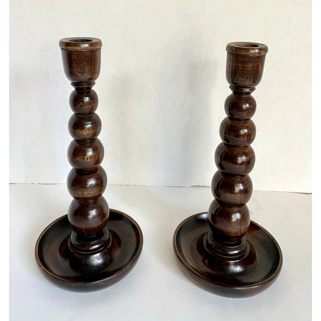 Here is a wonderful pair of solid wood candlestick holders in a bobbin style. The size of the round ball shapes increase...