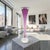 A signed studio art glass trumpet bud vase by Young & Constantin, model 109917, executed in a vivid ruby tone with a...