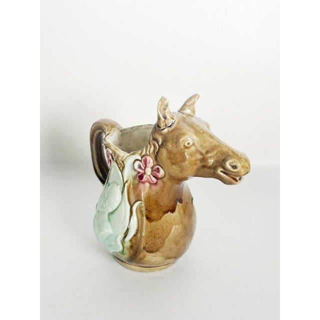 Beautiful 20th-century French majolica pitcher, distinguished by its charming sculptural horse-head spout, elegant curved...
