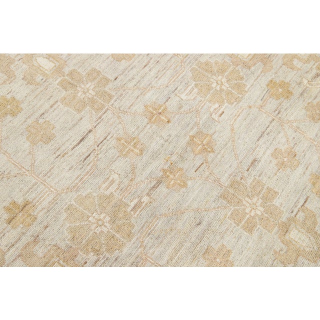 Beautiful Paki Peshawar hand-knotted wool rug with a gray color field. This modern rug has beige and tan accents in a...