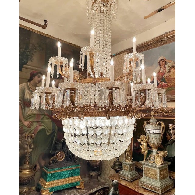 This chandelier appears to be a French crystal chandelier, likely dating from the late 19th or early 20th century. These...