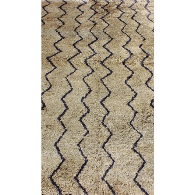 This stunning two-color Tulu rug features dark blue lines on a off sandy/taupe background. The pile is lush and of very...