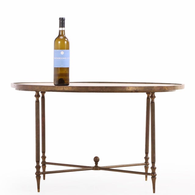 A finely crafted brass frame surmounted by a tessellated onyx top. The elegant design reflects the neoclassical influence...