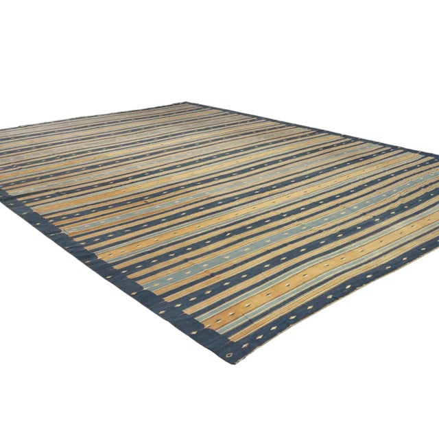 This vintage 16x22 Dhurrie flat weave runner is an exciting new entry in Rug & Kilim’s esteemed collection. Handwoven in...