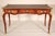 Antique Louis XV style king wood and tulip wood gilt bronze mounted desk with a tooled leather top, circa 1907. The top...