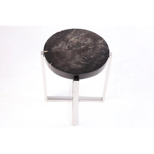 The top of this modern accent side table is made of one slice of organic petrified wood, hand polished to show its...