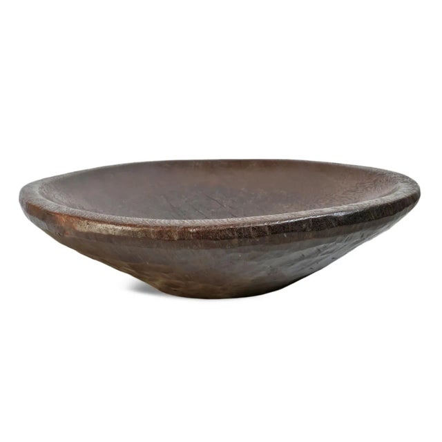 Heavy solid antique hand carved wood bowl from Indonesia region. Old wood with signs of age and rich brown finish used to...