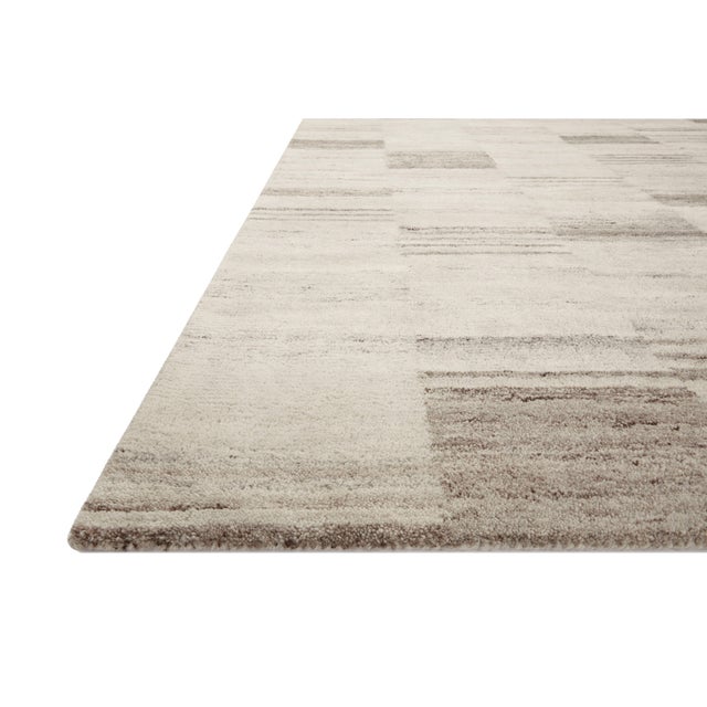 The Rocky Collection area rug by Amber Lewis x Loloi is uniquely hand-tufted with undyed wool to create a subtle and...