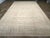A wool pile of symmetric knots on a cotton foundation. This extra-large Moroccan town piece features a strongly muted...