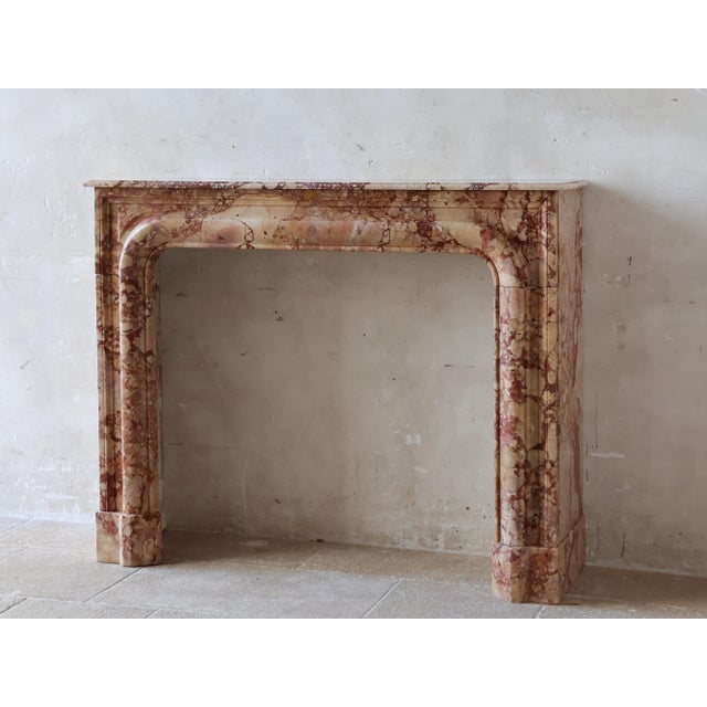 19th-century French mantelpiece crafted from Brèche de Montmeyan marble. The boudin model is characterized by its rounded,...
