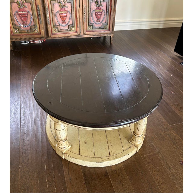 A beautifully designed round coffee table featuring a striking two-tone finish in white and wire-brushed tobacco. The...