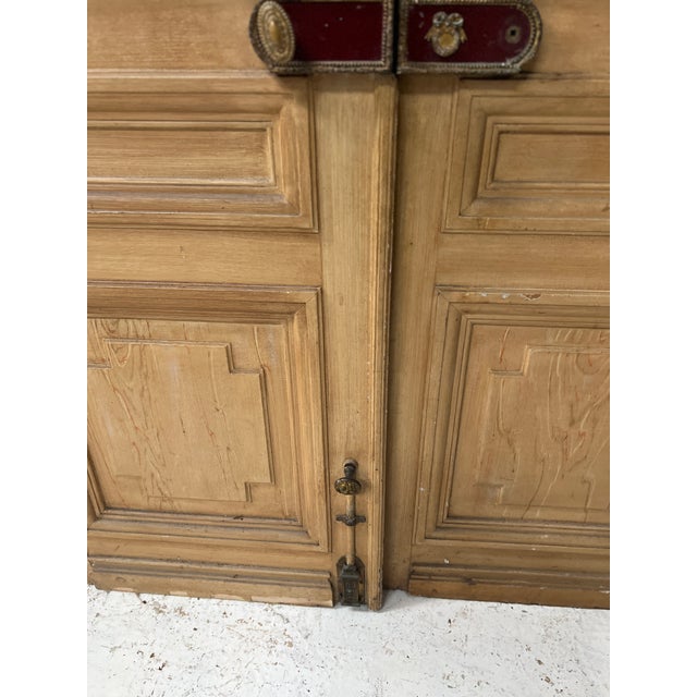 Pair of Haussmann-style double doors in patinated oak One double door is double-sided in patinated oak The other double...